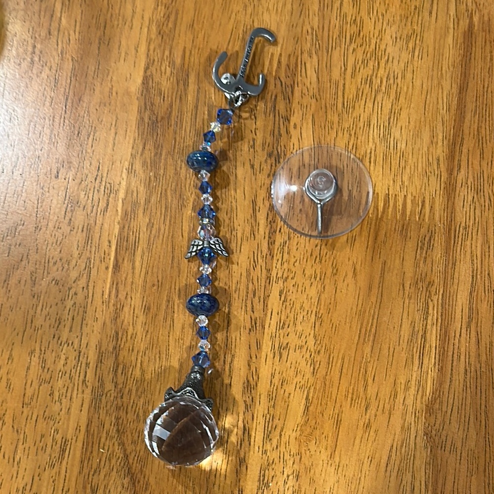 Crystal and silver hanging charm. Faceted clear crystal ball catches light